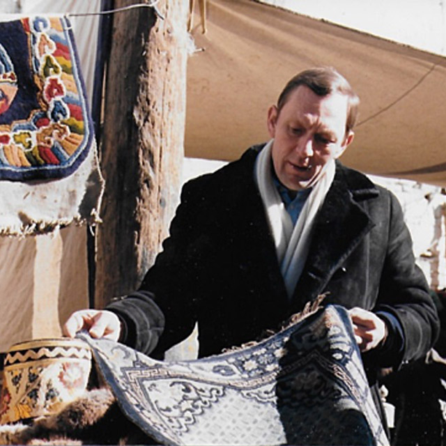 man selects rugs and kilims at the bazar in Istanbul